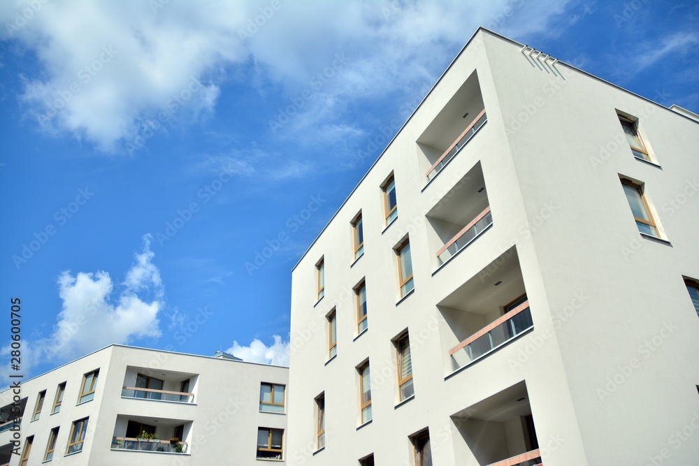 modern apartment building with blue sky and clouds