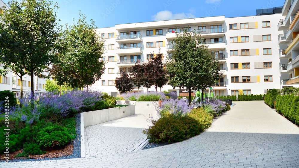 Modern multi-storey luxury housing concept. Modern apartment building with blue sky and clouds.