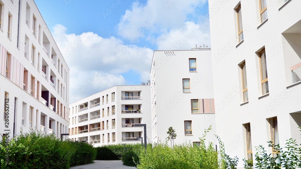 Modern multi-storey luxury housing concept. Modern apartment building with blue sky and clouds.