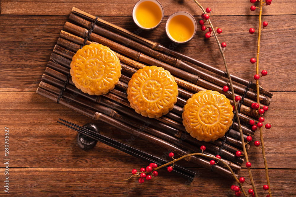 Moon cake Mooncake table setting - Chinese traditional pastry with tea cups on wooden background, Mi