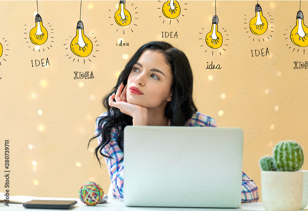 Idea light bulbs with young woman using a laptop