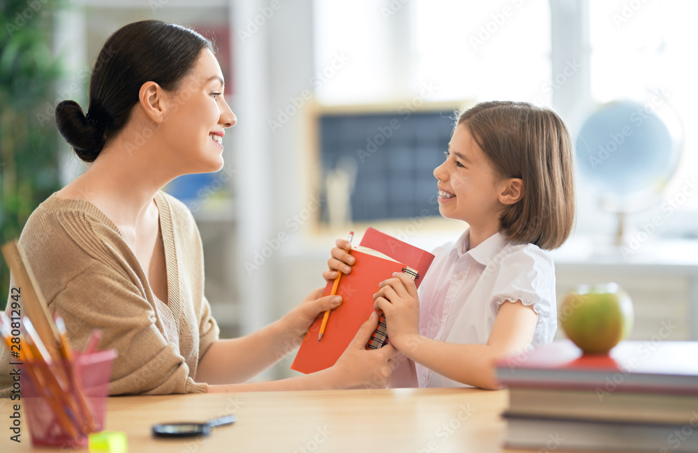 Girl with teacher in classroom.