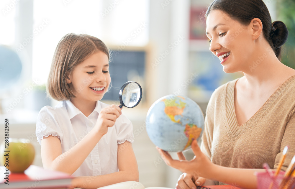 Girl with teacher in classroom.