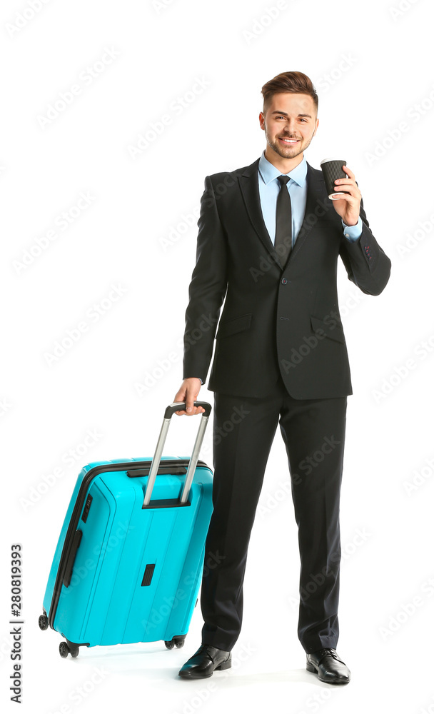 Handsome young businessman with luggage on white background