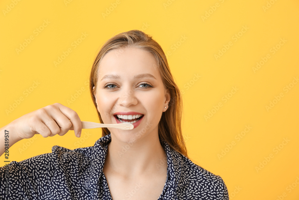 Happy woman with toothbrush on color background