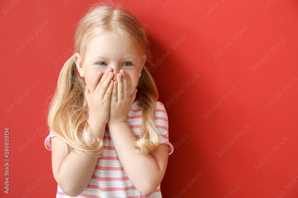 Portrait of adorable little girl on color background