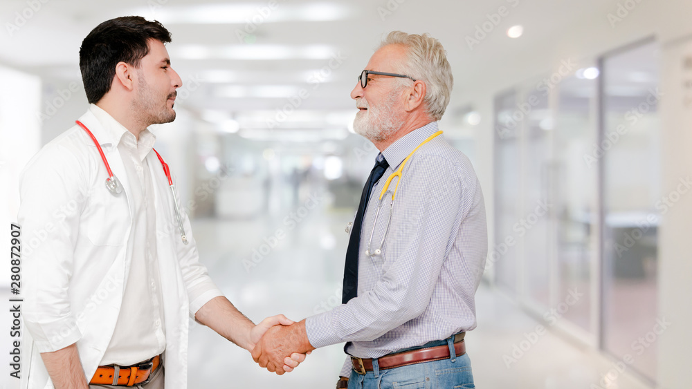 Doctor in hospital handshake with another doctor. Healthcare people teamwork and medical service con