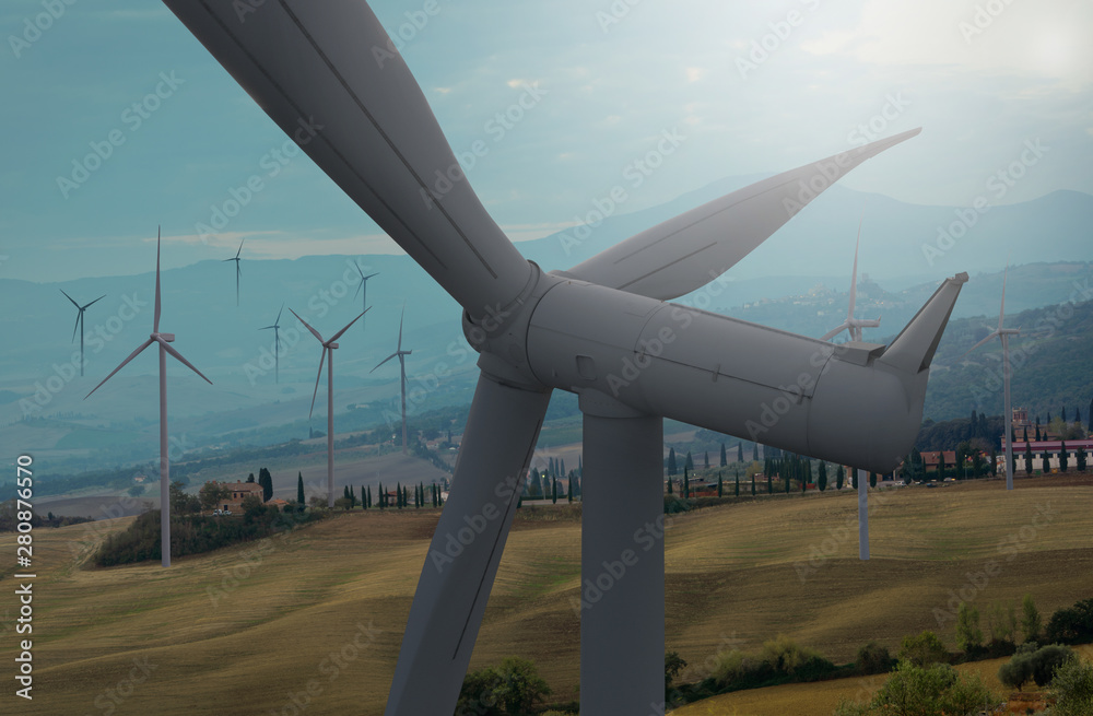 Wind turbine farm power generator in beautiful nature landscape for production of renewable green en