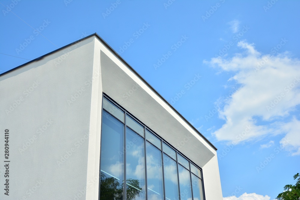 modern office building with blue sky and clouds