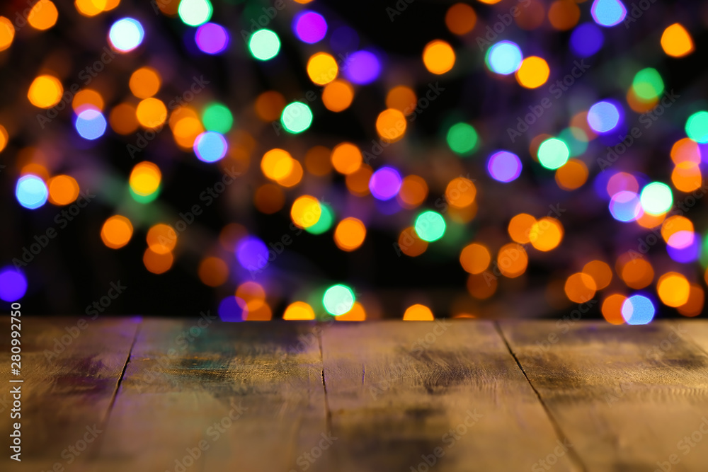 Wooden table and colorful defocused lights