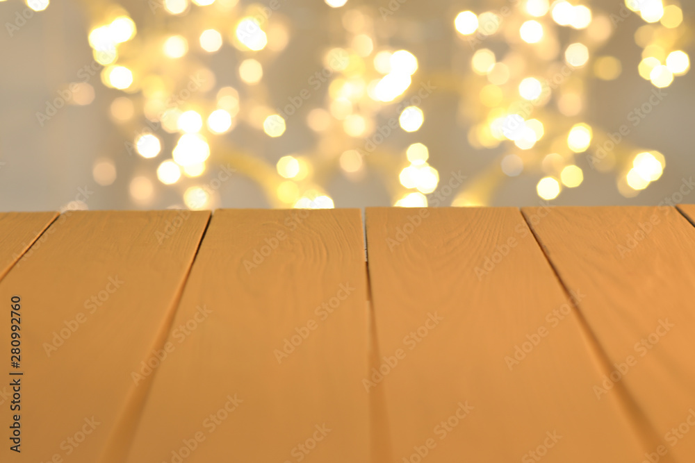 Wooden table and colorful defocused lights