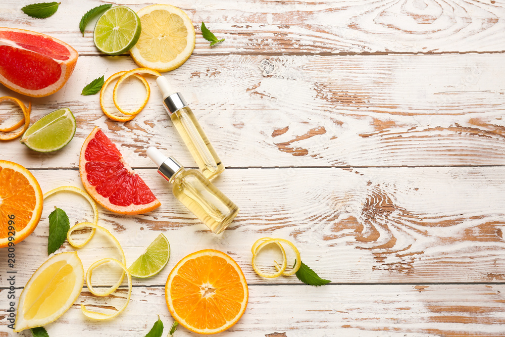 Composition with citrus essential oil on wooden background