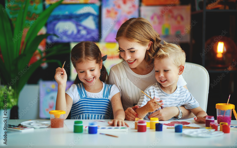 mother and children son  and daughter painting draws in creativity in kindergarten.