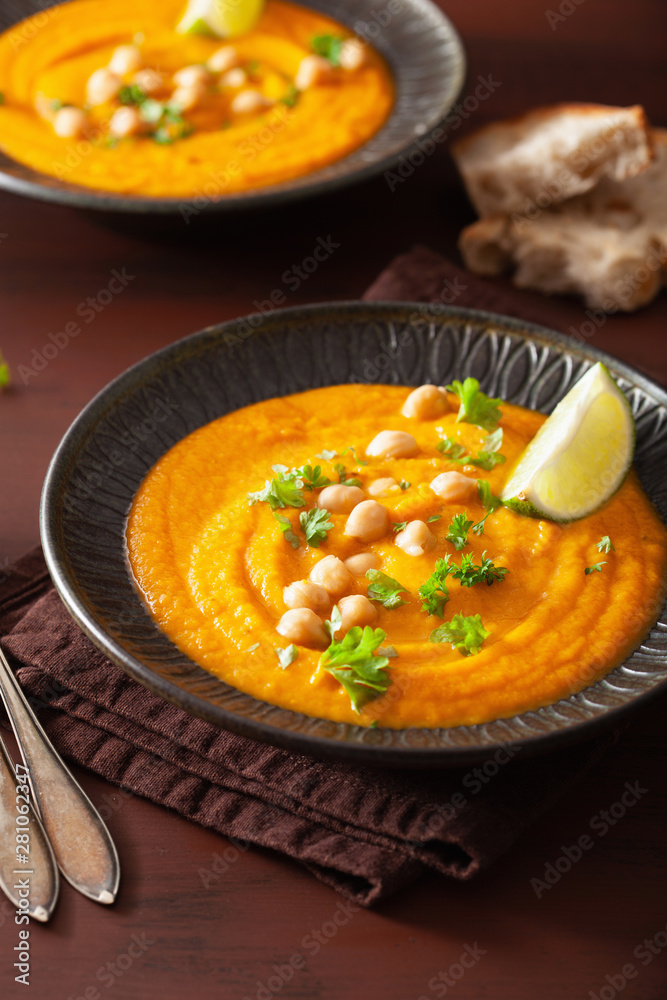 creamy carrot chickpea soup on dark rustic background