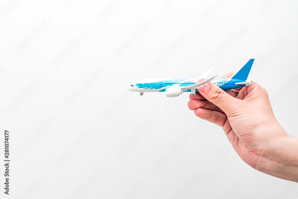 Flying concept picture of hand held aircraft model under white background