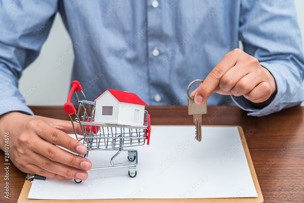 Real estate agent holding keys in hand