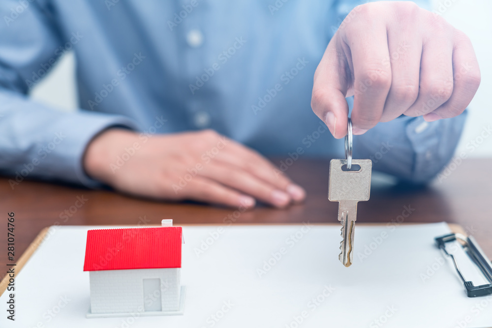 Real estate agent holding keys in hand