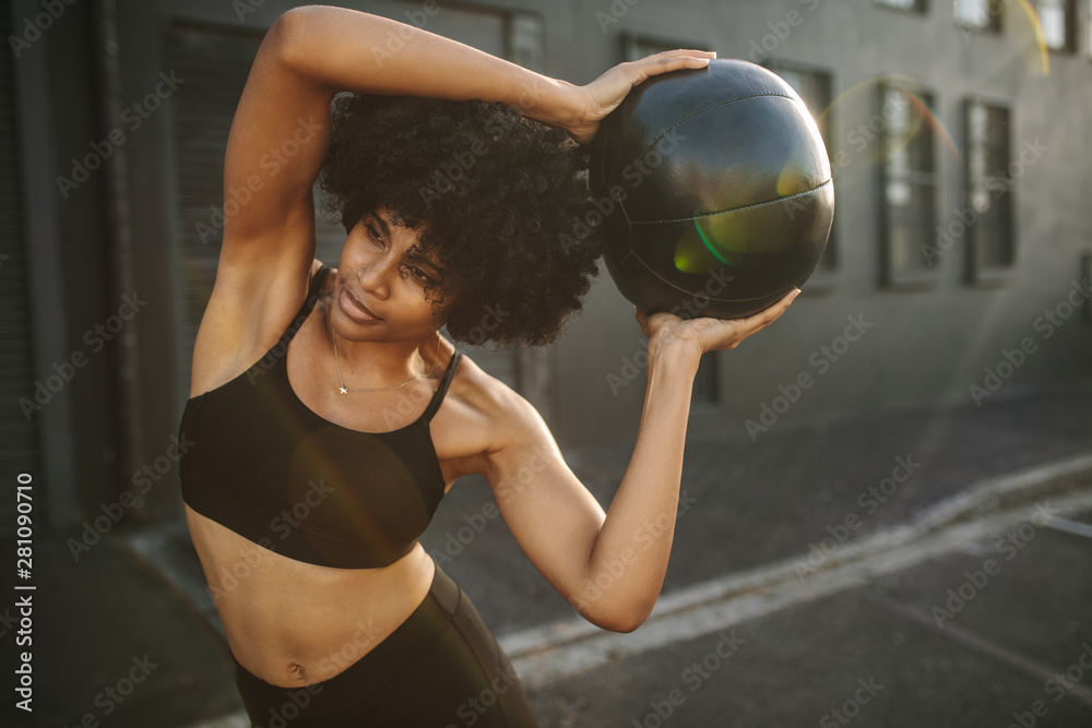 Fit woman exercising with fitness ball