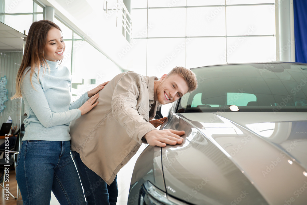 Couple choosing new car in salon