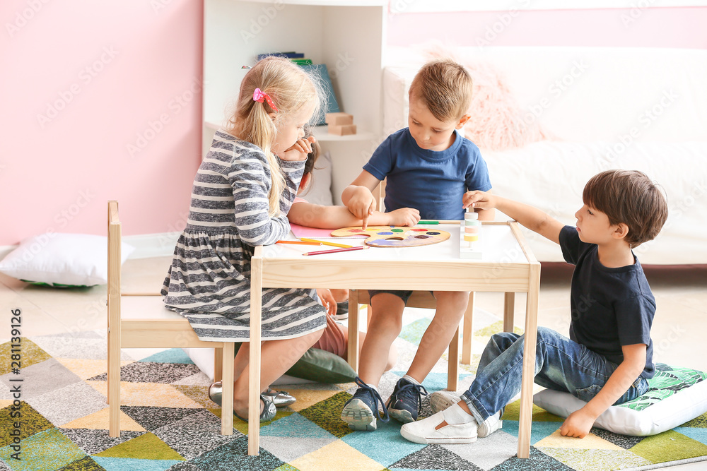 Cute little children playing in kindergarten