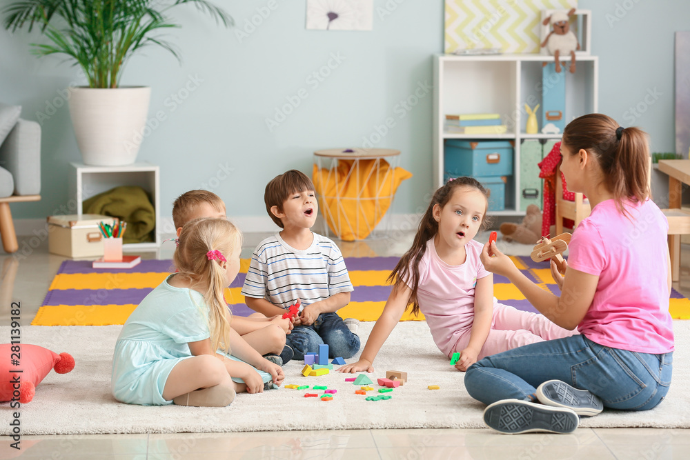 Cute little children learning letters in kindergarten