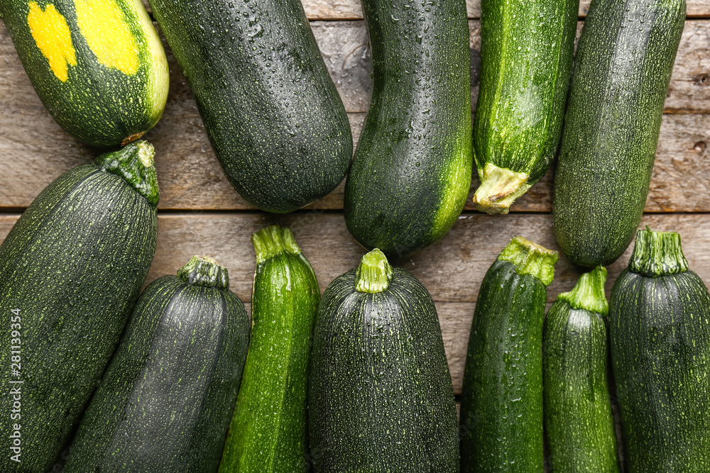 Fresh zucchini squashes on wooden background