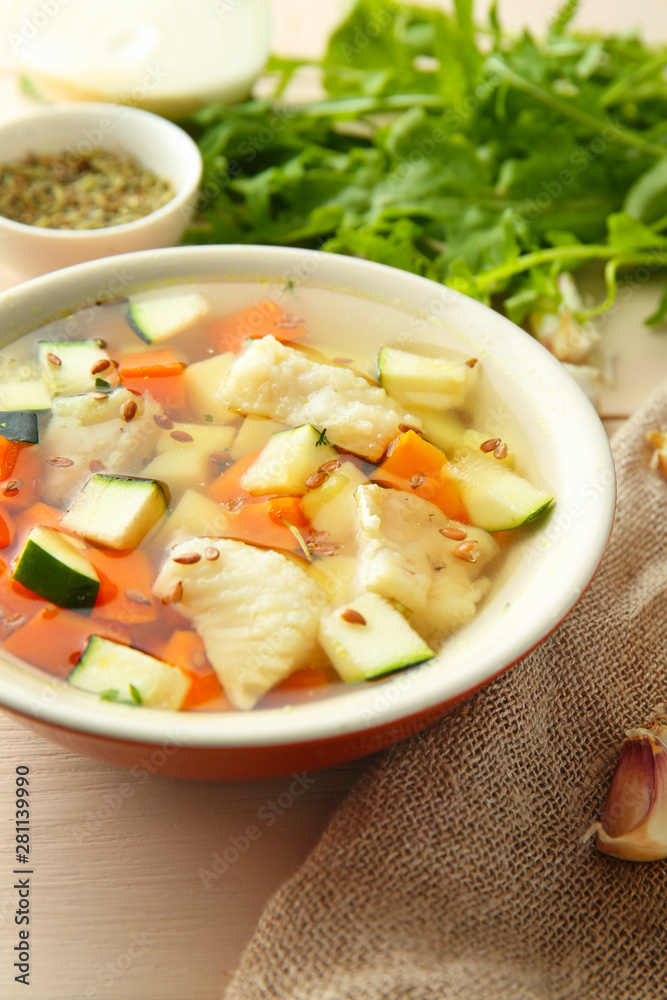 Bowl of tasty soup on table