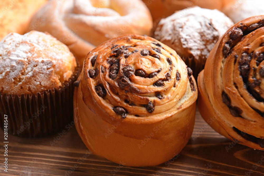 Tasty pastries on wooden background, closeup