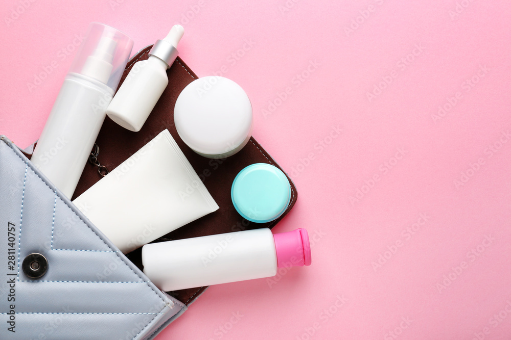 Bag with set of cosmetic products on color background