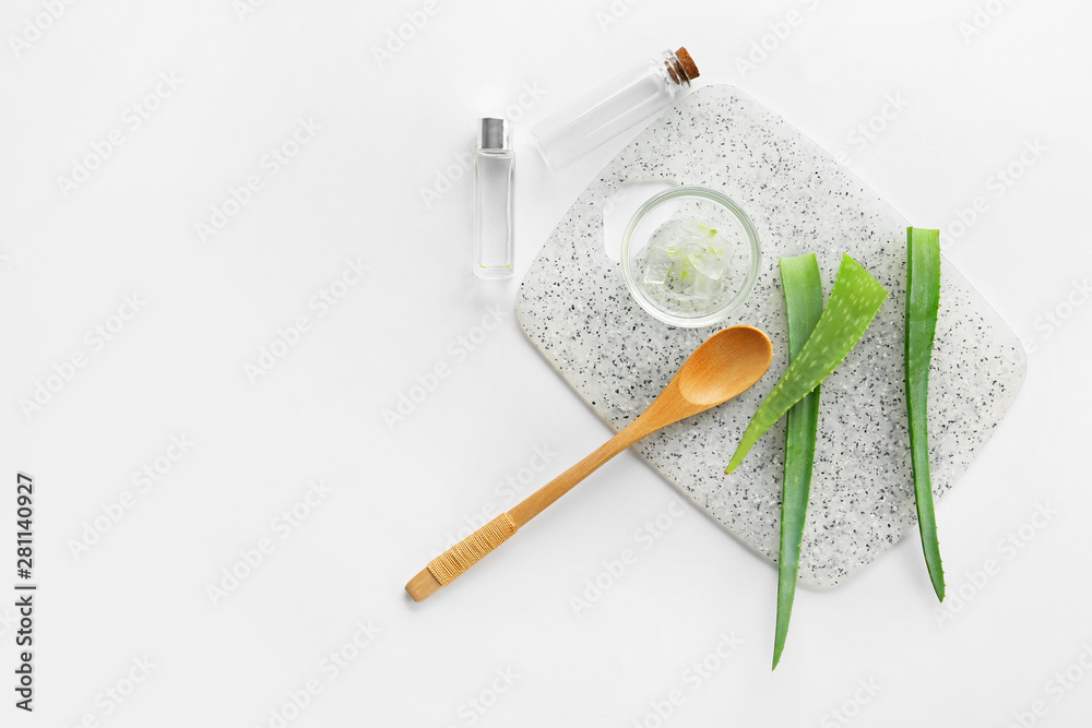 Fresh aloe leaves with essential oil on white background