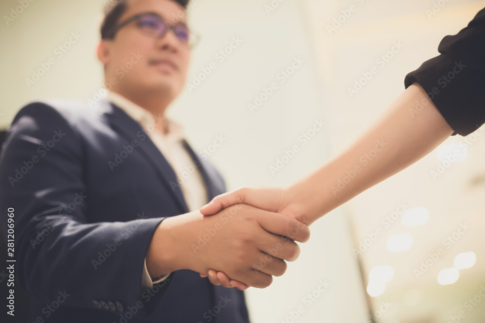 Business people shaking hands, between meeting in seminar room