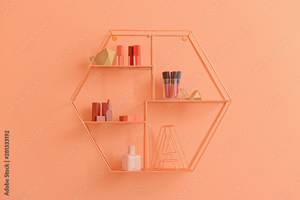 Stylish shelf with makeup cosmetics on color wall