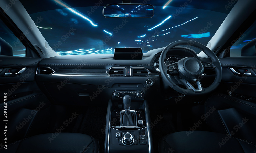 Modern black car dashboard interior with moving motion blur street background, luxury car interior c