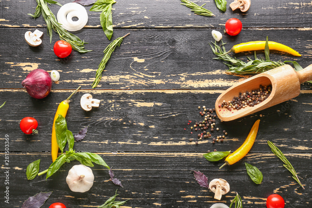 Fresh herbs with vegetables and spices on dark wooden background