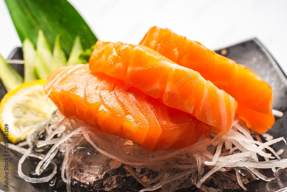 Sashimi, Salmon, Japanese food chopsticks and wasabi on the wood table