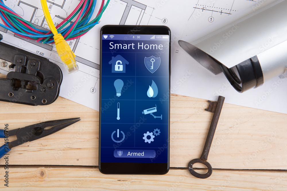 Home security concept smartphone with smart home app and surveillance cctv camera on the desk