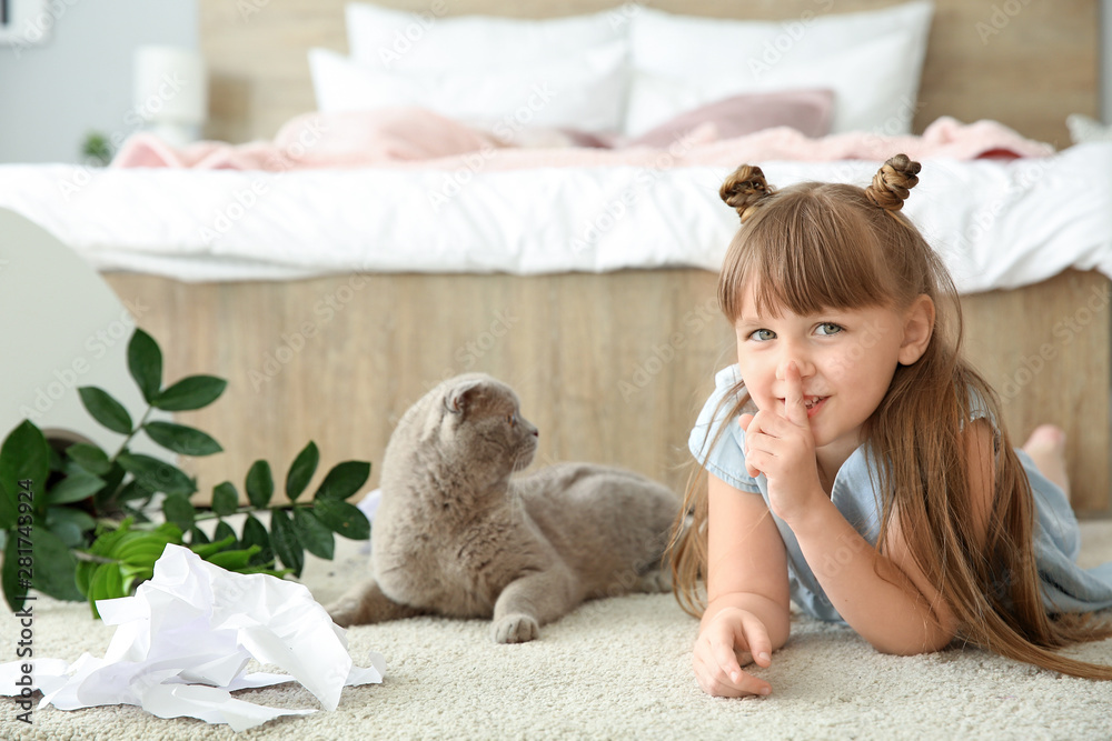 Little girl and cute cat in room with dropped houseplant and paper pieces on carpet