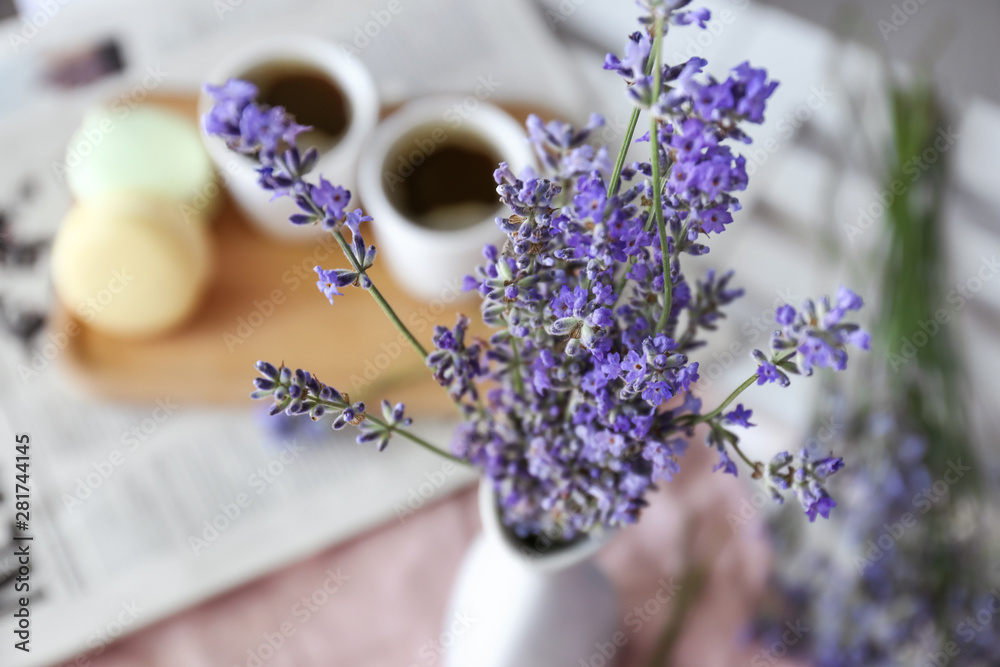 Beautiful lavender flowers in vase on table, closeup