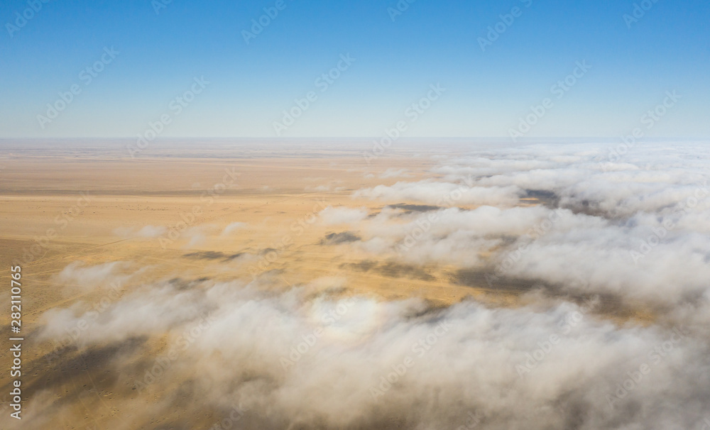 Coastal fog rolling over the desert landscape of Skeleton coast. Skeleton coast, Namibia.