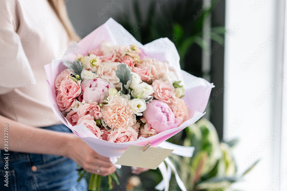 Pink peonies. Beautiful bouquet of mixed flowers in woman hand. Floral shop concept . Handsome fresh