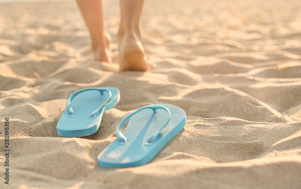 Flip-flops on sand beach at resort