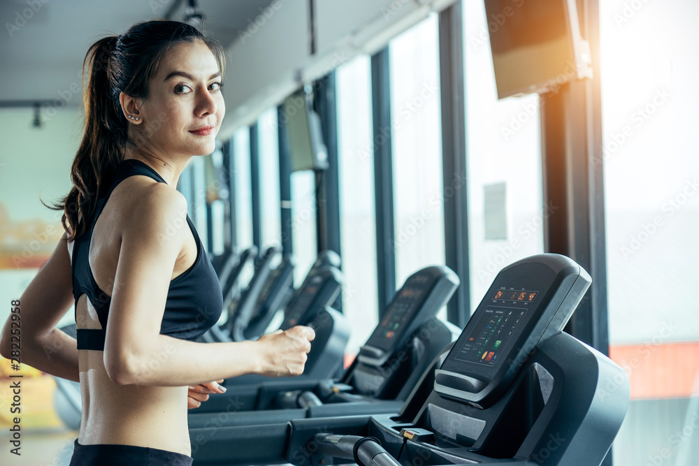 Asian woman exercising in the gym, Young woman workout in fitness for her healthy and office girl li