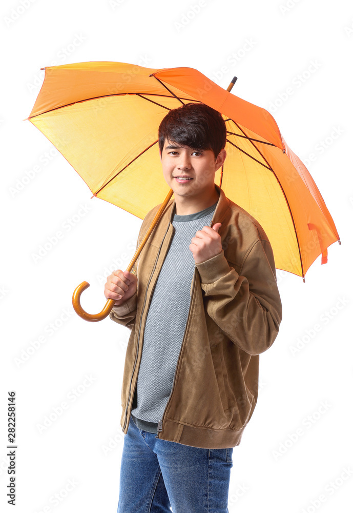 Handsome Asian man with umbrella on white background