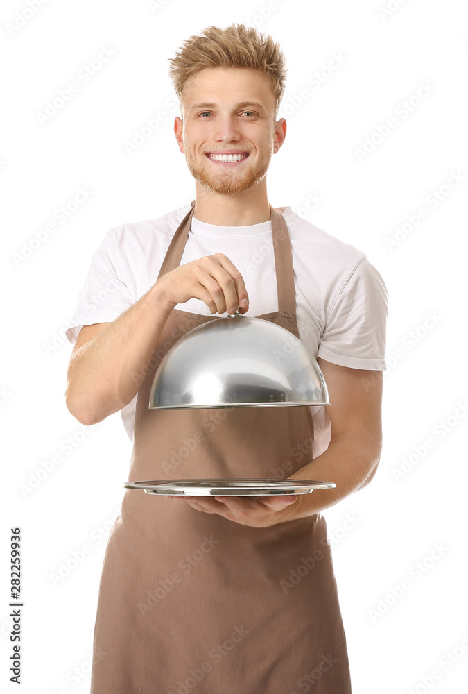 Handsome male chef with tray and cloche on white background