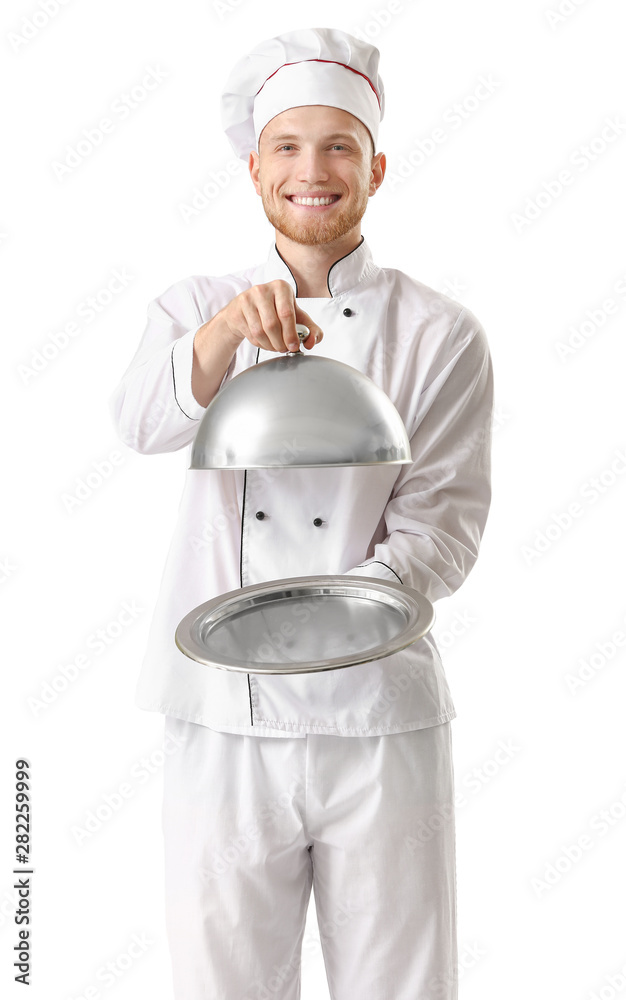 Handsome male chef with tray and cloche on white background