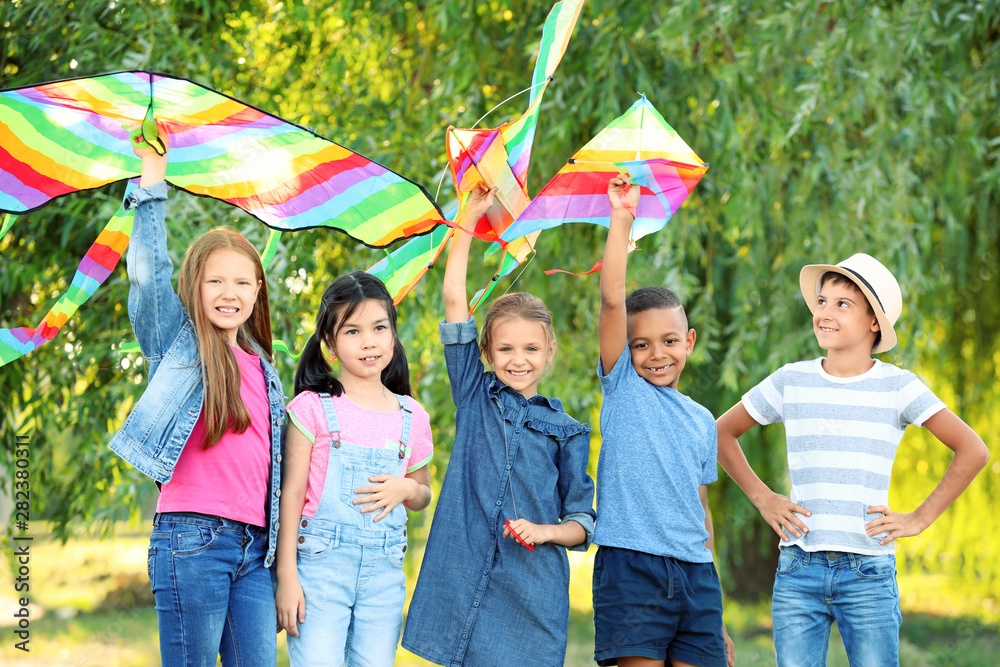 Little children flying kites outdoors