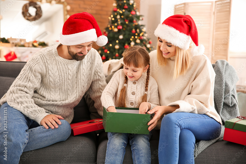 Happy family with Christmas gifts at home