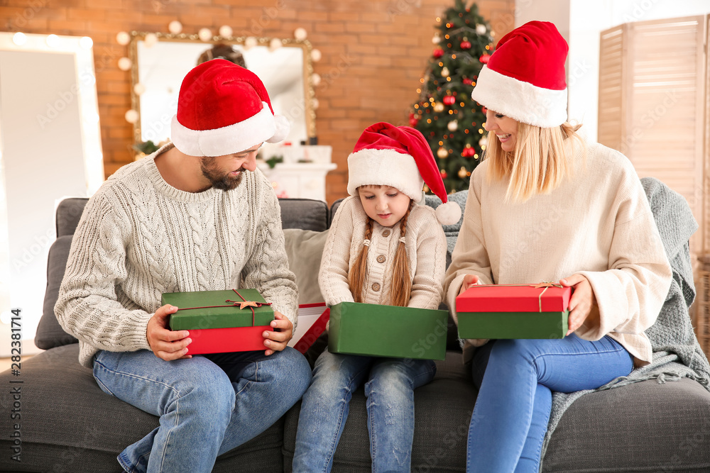 Happy family with Christmas gifts at home