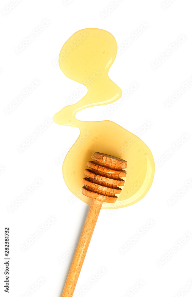 Wooden honey dipper on white background