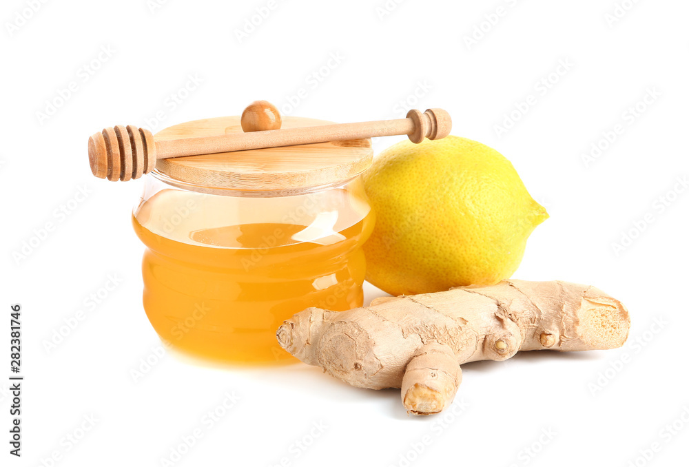 Jar of fresh honey, lemon and ginger on white background